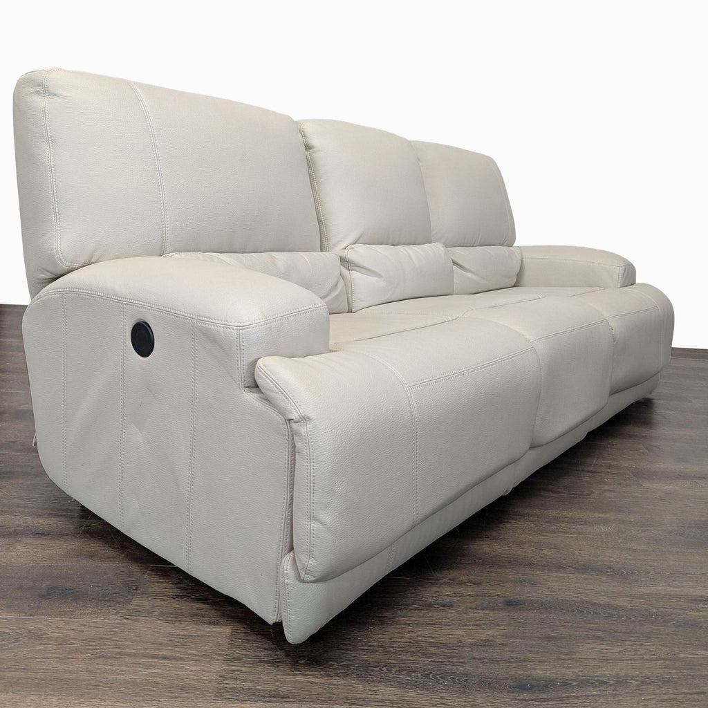 Cream leather Ikea 3-seat sofa with reclining seats, supportive backrests, and contemporary look for any living room.