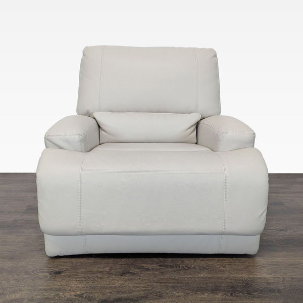 Ikea lounge chair in beige leather with wide armrests and recliner function, perfect for living rooms.