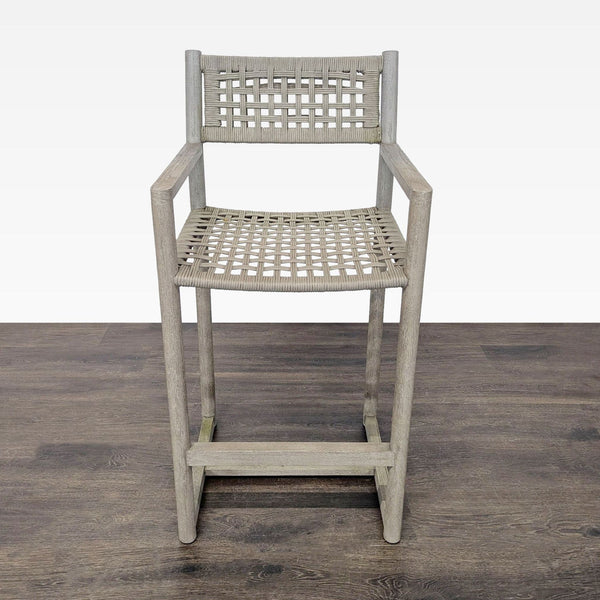 Restoration Hardware bar chair with teak wood frame and woven seat, featuring armrests and footrest.