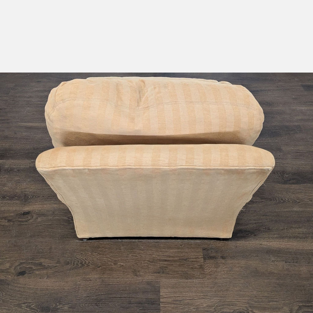 Classic Crate & Barrel lounge chair with cozy striped upholstery, inviting cushions, and elegant, turned legs.