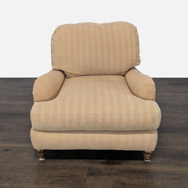 Crate & Barrel lounge chair with beige striped fabric, rolled arms, and turned wooden legs for a classic look.