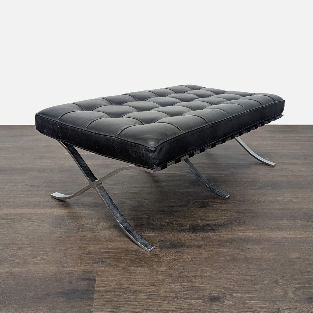 Modern ottoman with a cushioned top, leather strap accents, and chrome X-shaped legs.  