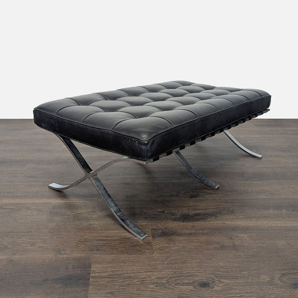 Modern ottoman with a cushioned top, leather strap accents, and chrome X-shaped legs.  