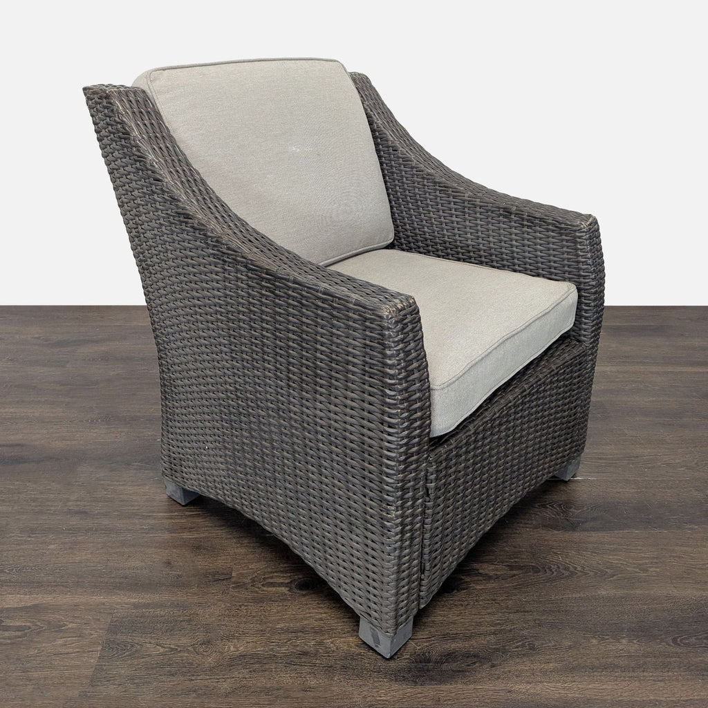 Neutral Threshold armchair with a wicker frame and soft cushions, suitable for indoor or outdoor seating.