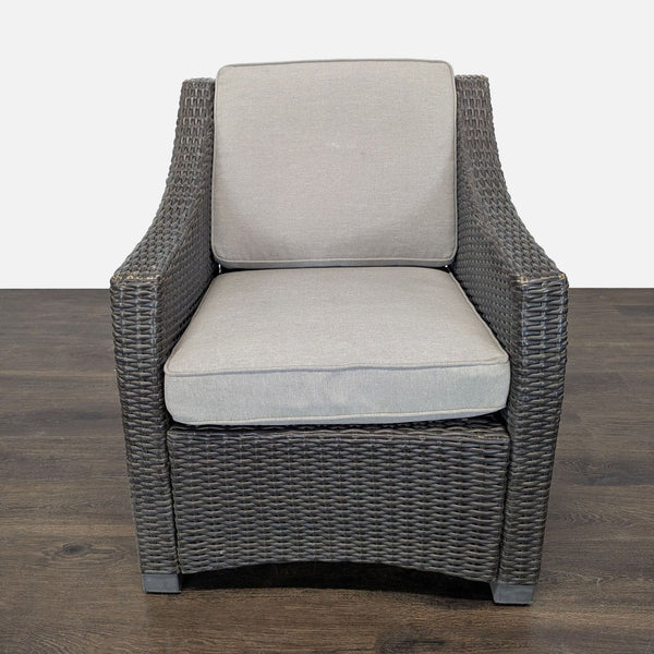Threshold wicker armchair with removable cushions, featuring wide armrests and neutral tones for versatile use.