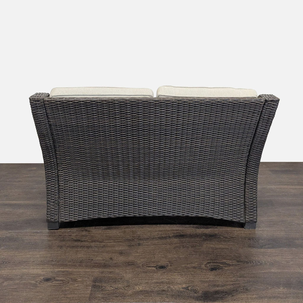 Gently used Threshold two-seater chair, featuring sturdy woven design and soft gray cushions for comfort and style.