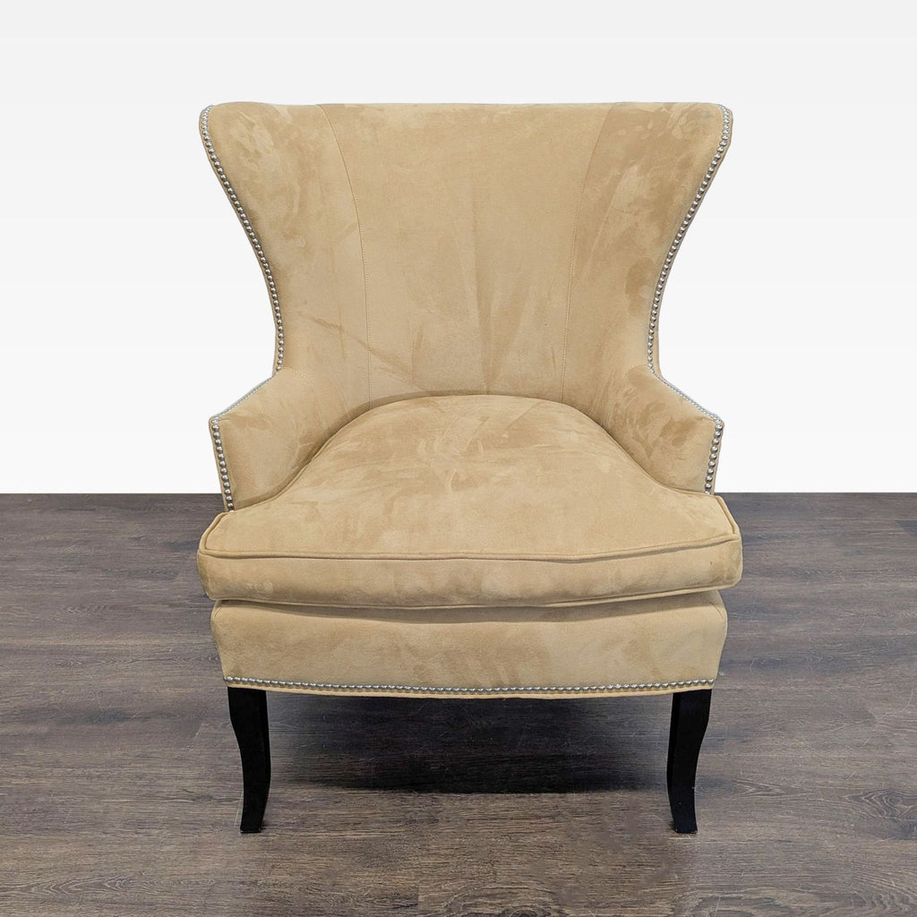Plush Williams Sonoma Home lounge chair in soft tan fabric with silver accents and sturdy wooden legs.