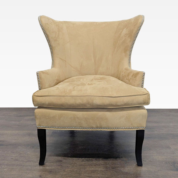 Williams Sonoma Home tan lounge chair with silver nailhead trim and dark wood legs, ideal for living rooms.  