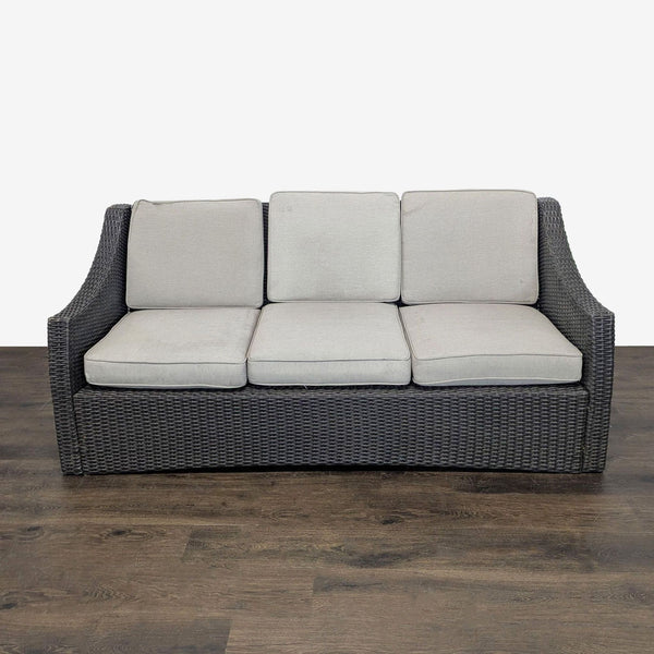 Dark brown wicker outdoor sofa with three plush cushions, perfect for patios, by Threshold, seats up to three.