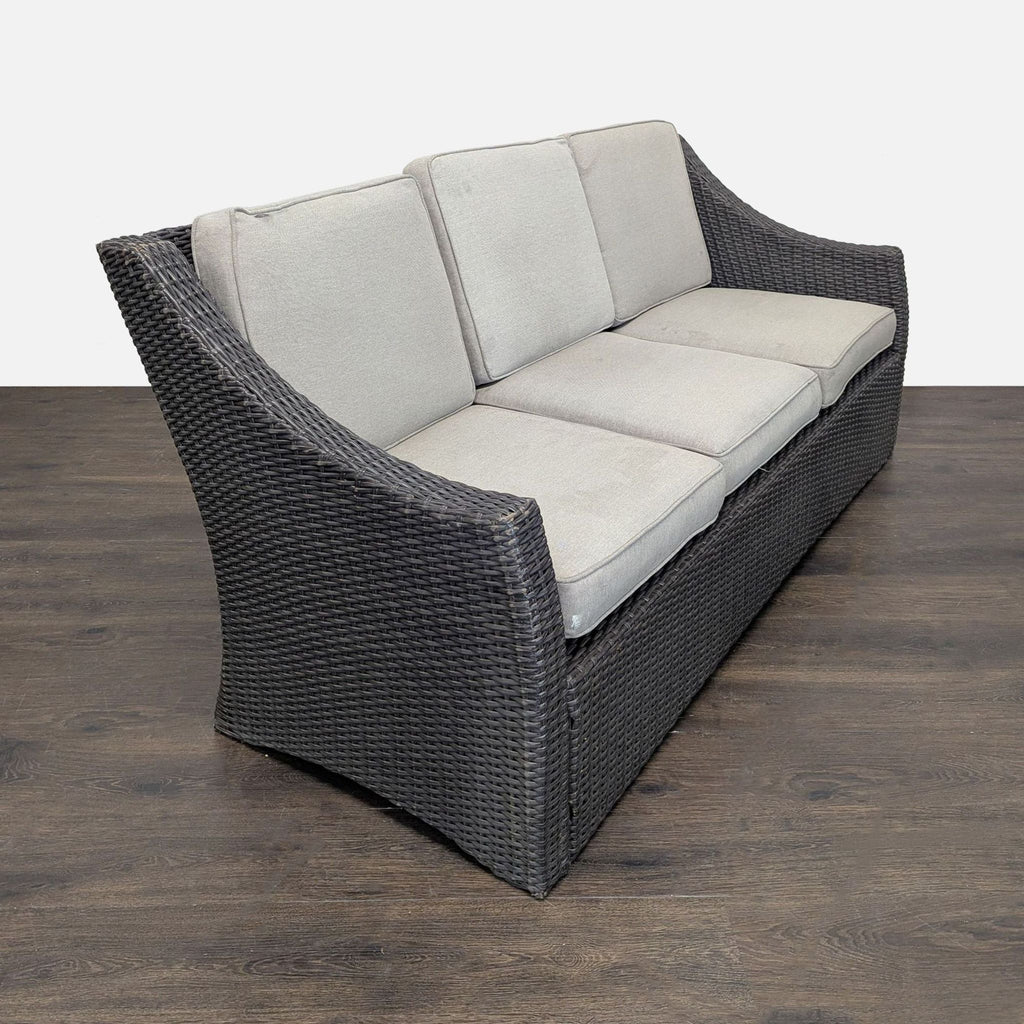 Three-seater Threshold outdoor sofa with weather-resistant wicker frame and soft back and seat cushions.