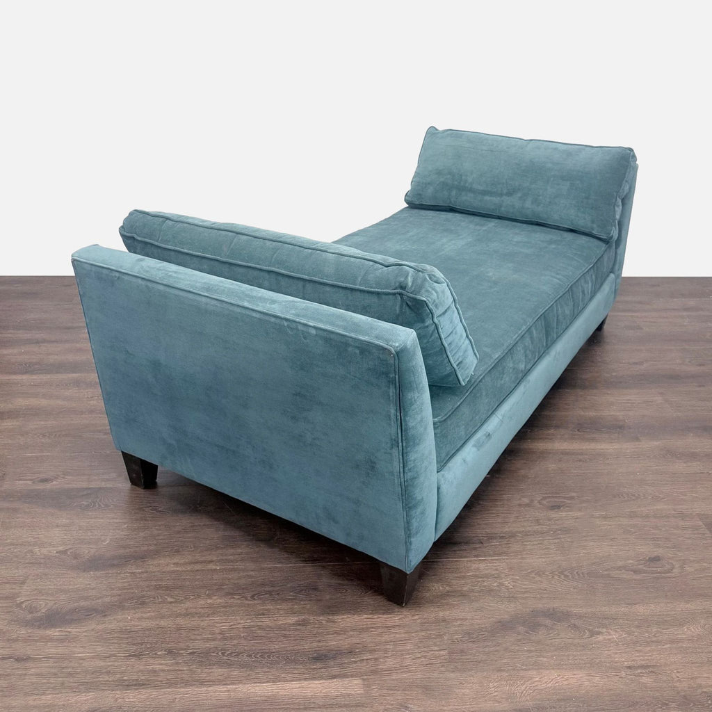 Living Spaces blue velvet chaise sofa, featuring soft fabric, roomy seating, and a sleek, modern design.