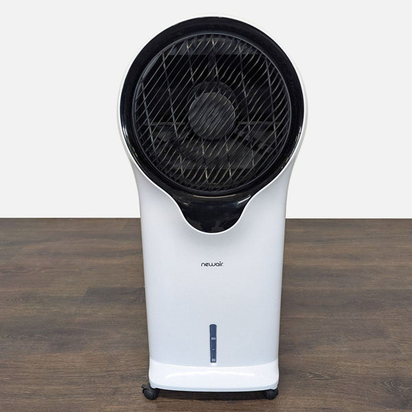 Compact Newair air cooler fan with wheels and visible water level, ideal for home or office cooling.  