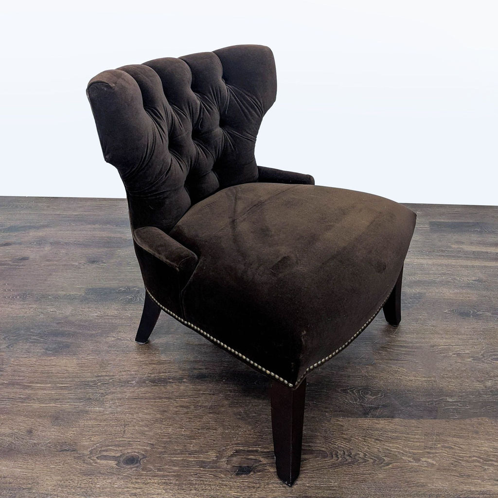 Elegant brown velvet tufted lounge chair by Pottery Barn with button detailing and sturdy dark wood legs.