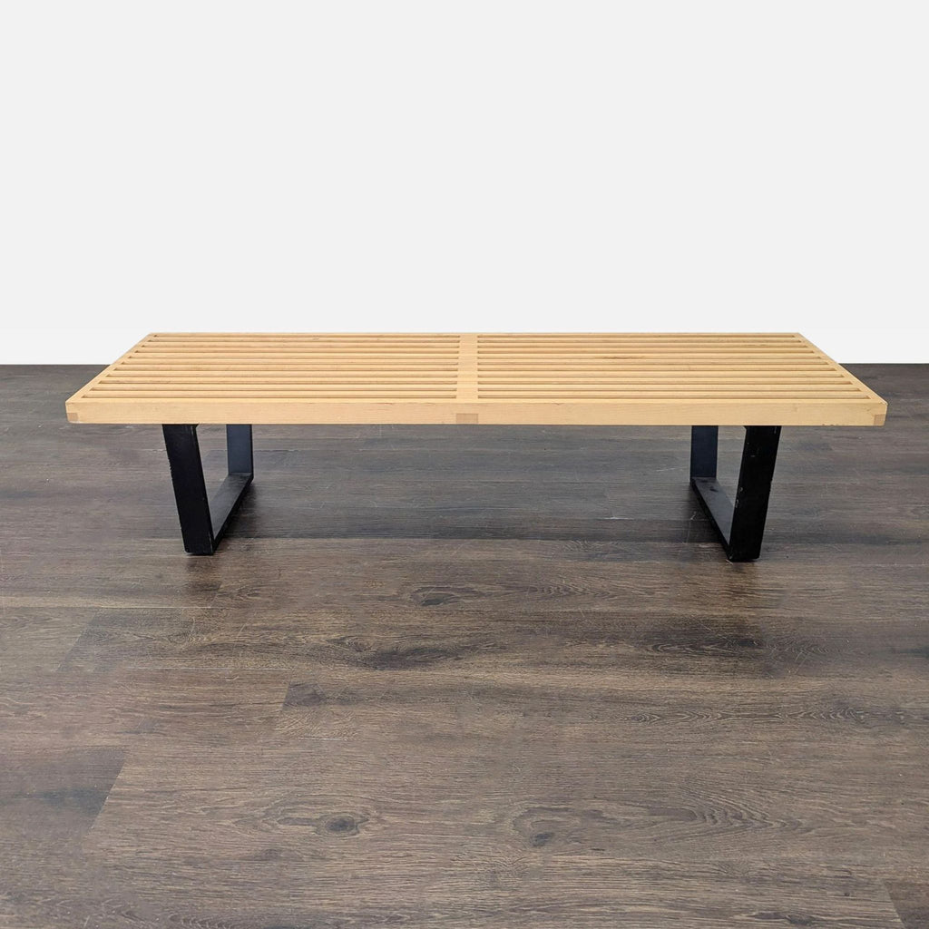 Rectilinear maple bench with black legs, showcasing George Nelson’s iconic modern design for Herman Miller.