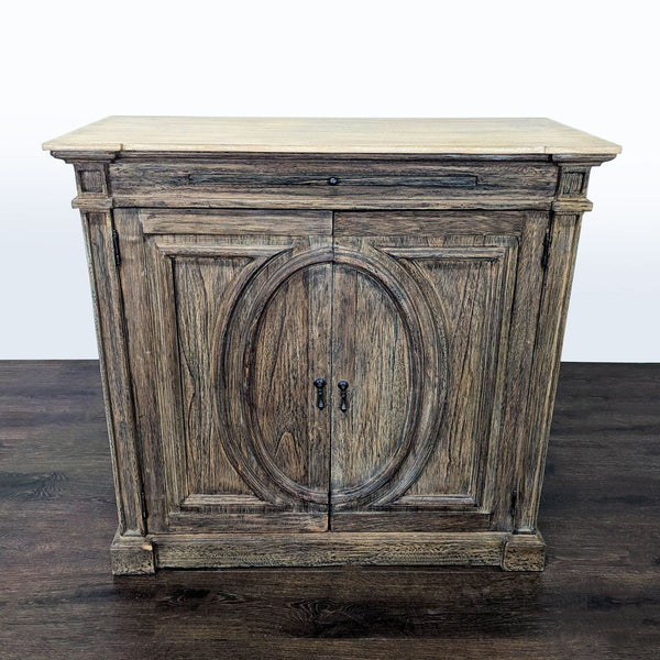 Rustic wooden cabinet with oval-patterned front doors and a spacious top tray surface for extra storage.