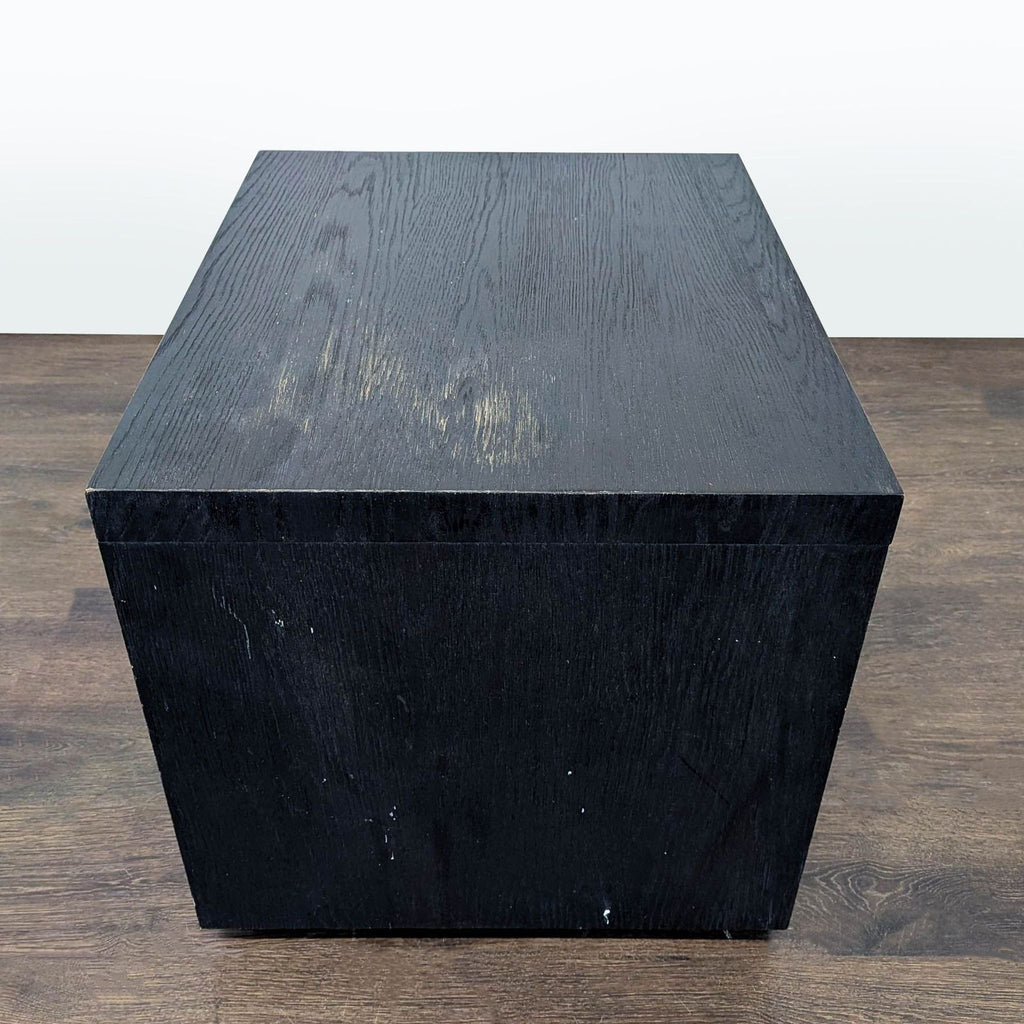 Modern black oak end table with slender chrome metal details, inspired by 1970s postmodern design.