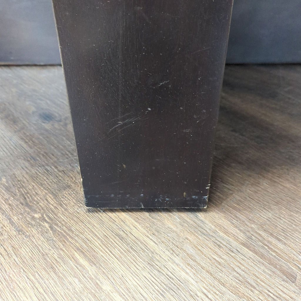 Plank wood coffee table highlighted by a bold black band trim for a modern rustic appeal.