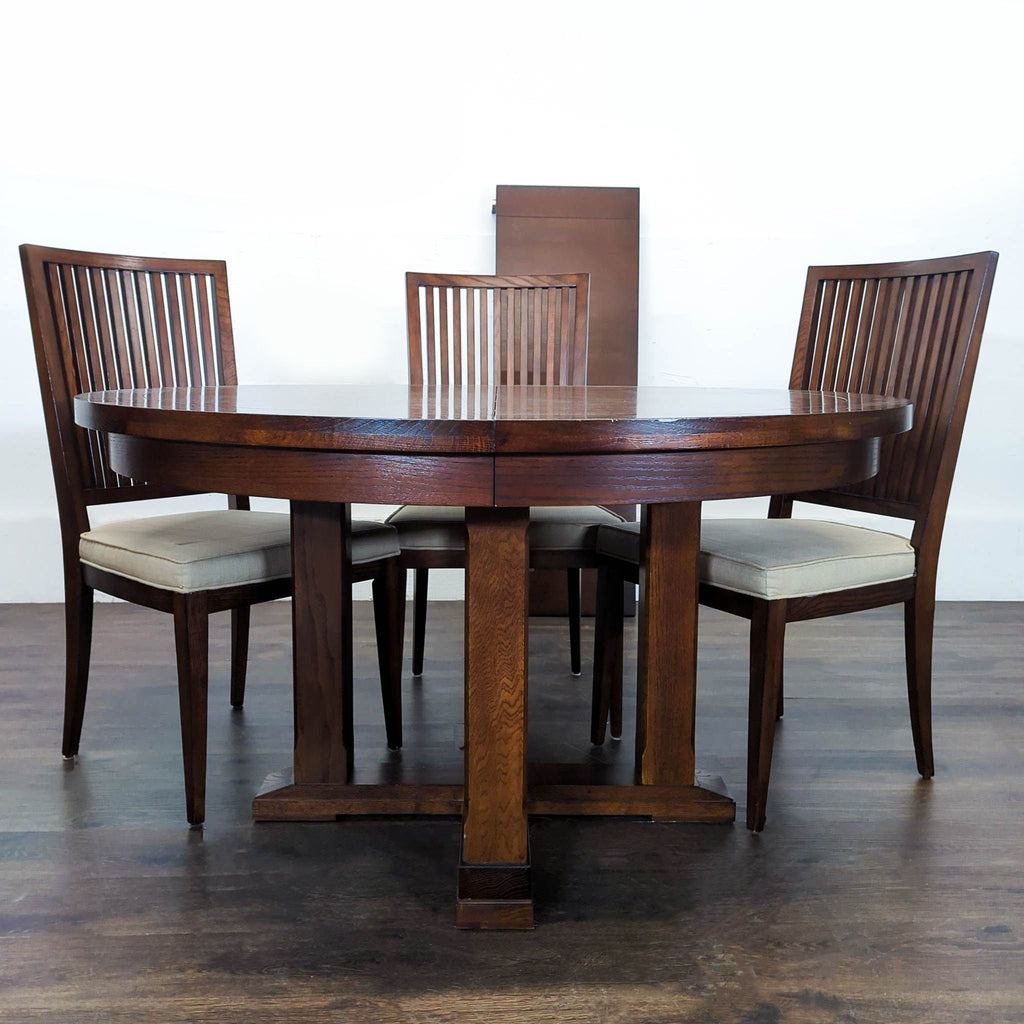 Round wooden dining set with extension leaf, six slat-back cushioned chairs, and elegant dark finish.
