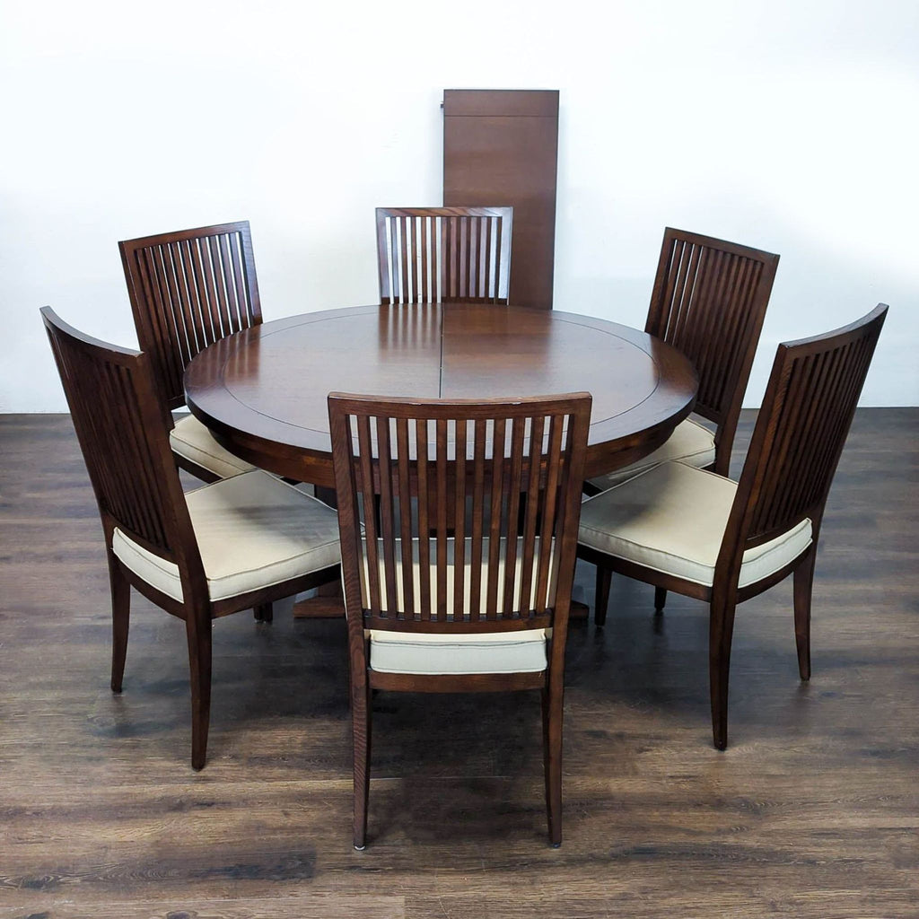 6-chair round dining table set in dark wood, featuring an extendable leaf and padded seats for comfort.