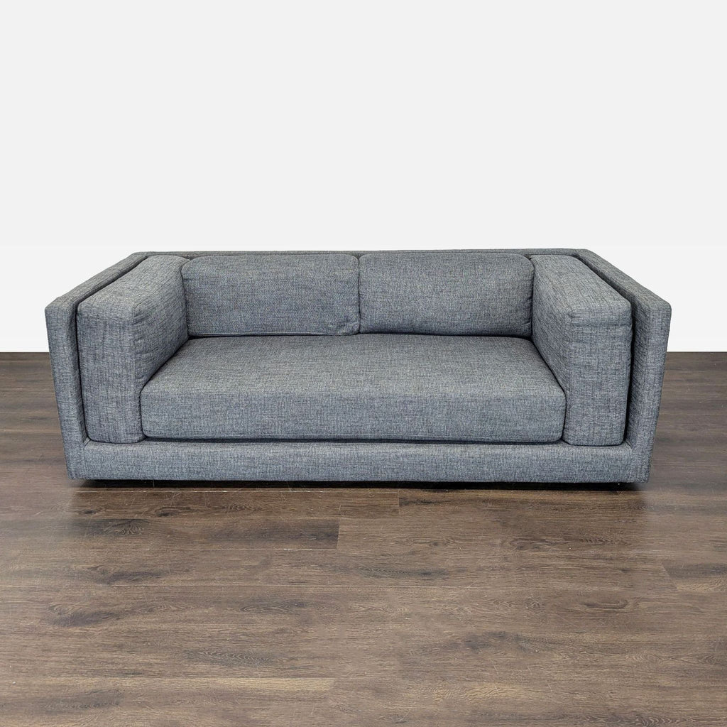 CB2 3-seat sofa in grey fabric with modern boxy design, clean lines, and supportive seat and back.