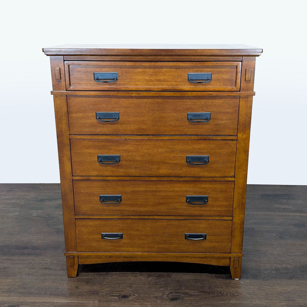 1. Ashley Furniture brown wood dresser with five drawers and black handles, perfect for bedroom storage.  