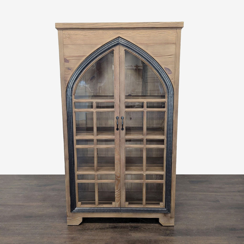 Solid pine cabinet with glass doors and cathedral-style frame, blending wood and metal by Grandin Road.  