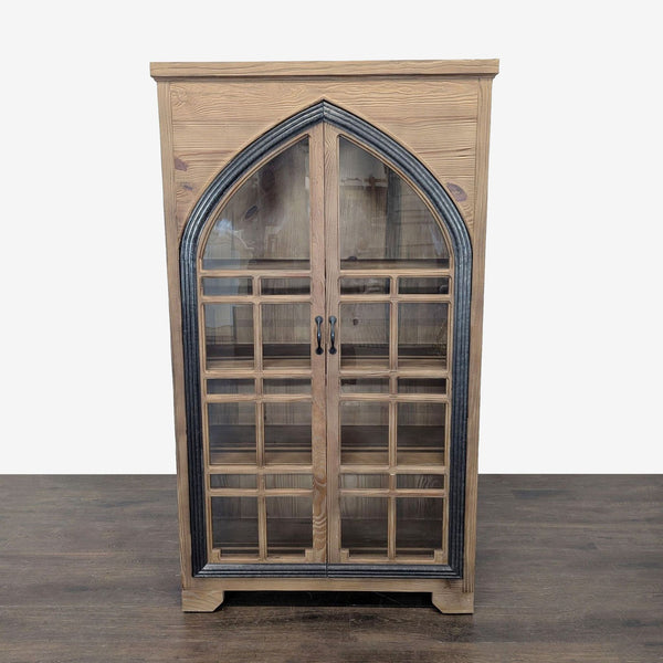 Solid pine cabinet with glass doors and cathedral-style frame, blending wood and metal by Grandin Road.  