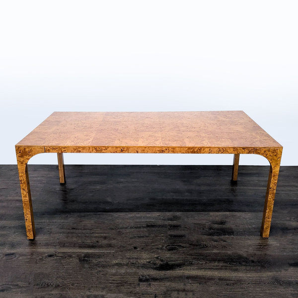 Sleek CB2 dining table with arched legs inspired by Roman aqueducts, finished in vintage burl wood veneer.