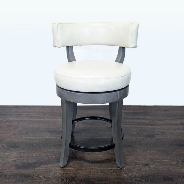 Solid wood stool with bonded leather seat, supportive low back, and carved, flared legs by Grandin Road.  