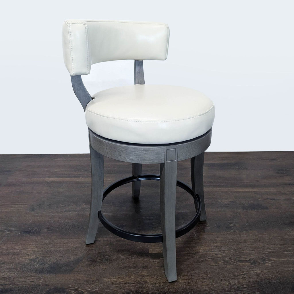 Grandin Road stool features a bonded leather cushion, lower backrest, and intricately carved wood legs.  