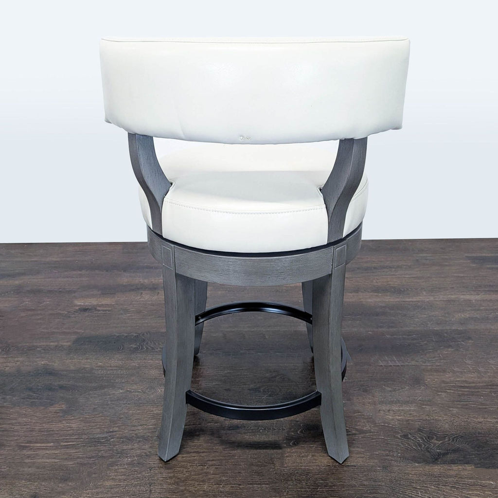 Elegant counter stool with inset-carved flared legs, low supportive back, and leather upholstery; Grandin Road brand.
