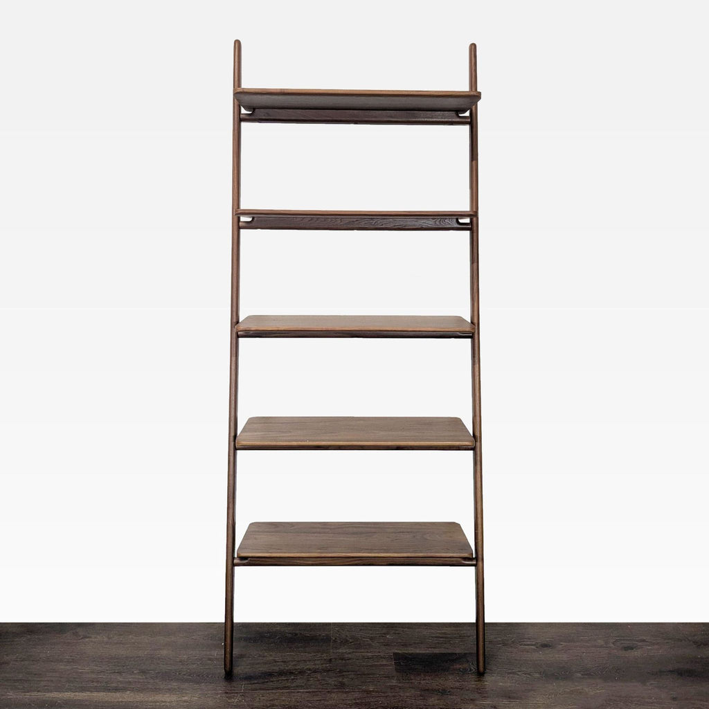 Wooden ladder bookshelf with five shelves for books or decor, showcasing minimalist design and natural finish.  