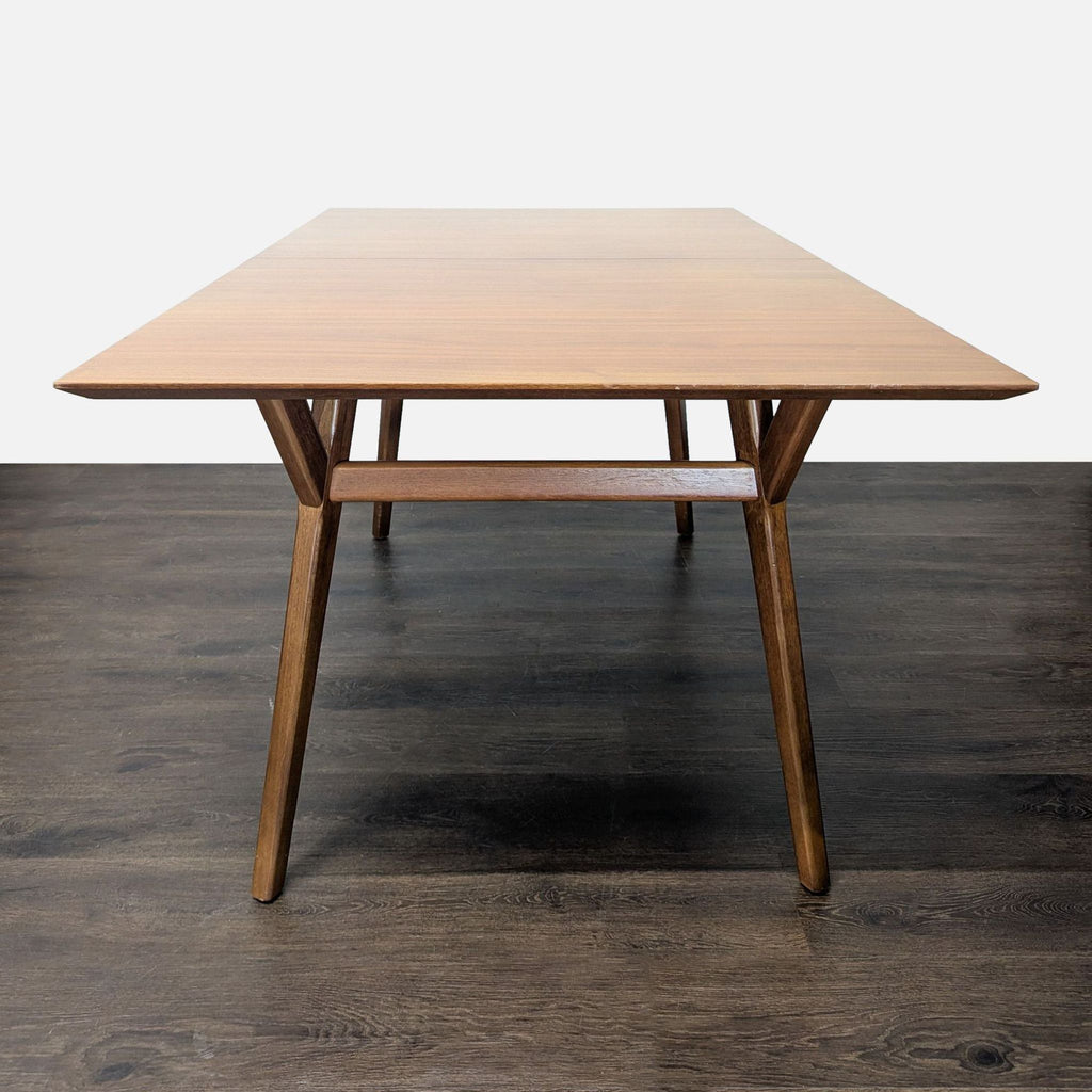 Modern West Elm dining set featuring a sturdy wooden table and six matching chairs for gatherings.