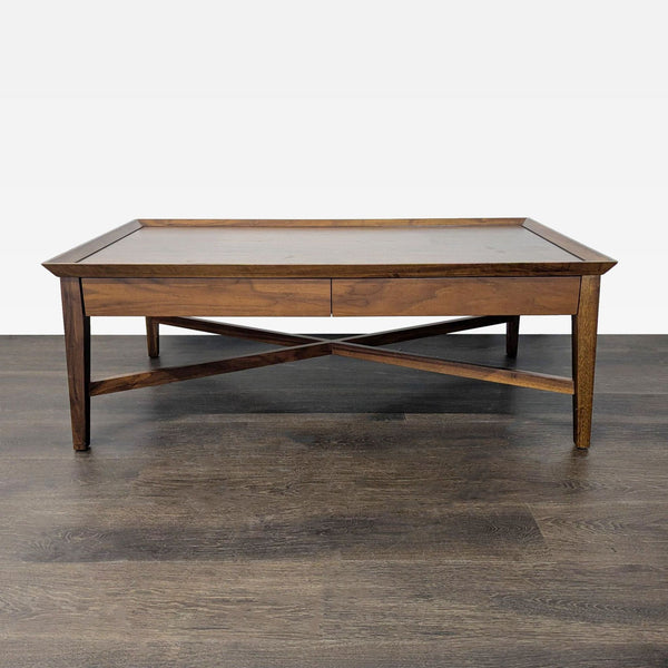 Crate & Barrel walnut coffee table with two drawers and X-braced sides, modern and stylish design.  