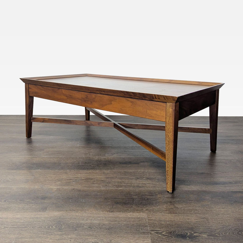Walnut coffee table by Crate & Barrel, includes dual drawers and decorative X-braced frame.