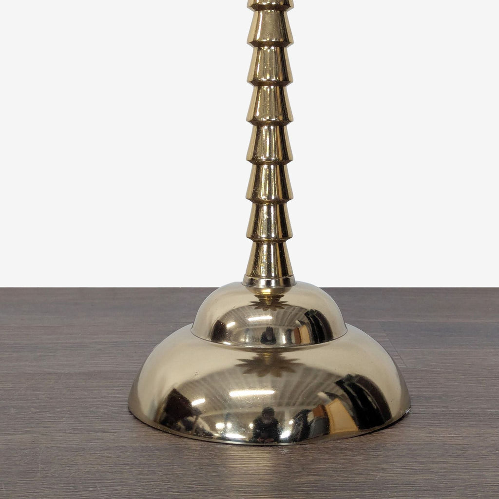 Gold metal palm tree base supports a glass top on this console table.  