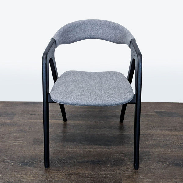 Modern dining chair with upholstered seat and back on a wooden frame by Design Evolution.  