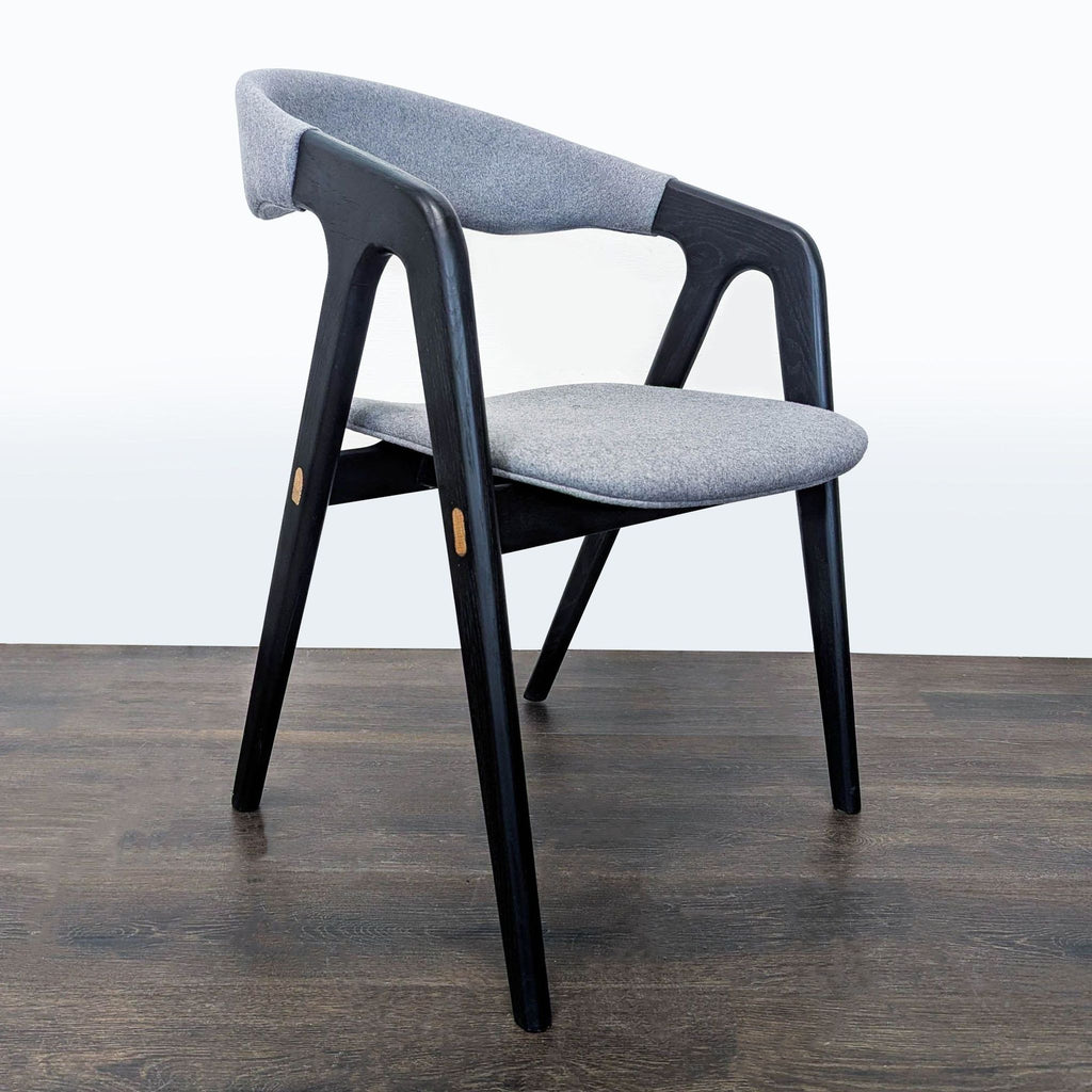 Minimalist Design Evolution dining chair featuring a cushioned back and seat, set on sturdy wood legs.  