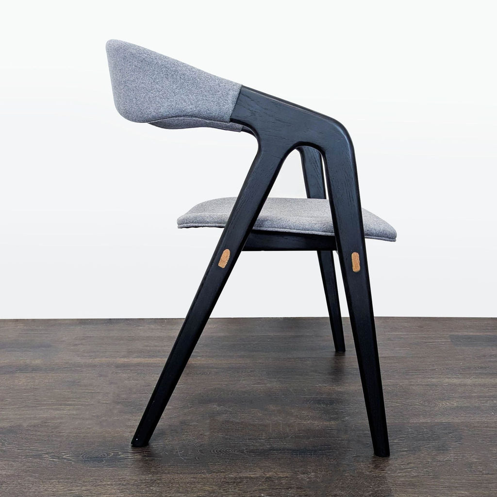 Elegant wood-framed dining chair with fabric upholstery, crafted by Design Evolution for dining spaces.