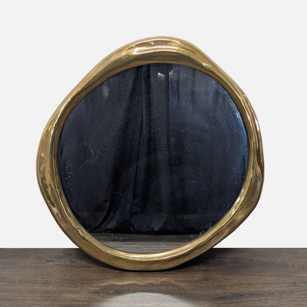 Organic-shaped circular wall mirror with undulating resin frame, antique finish, by Regina Andrew.  