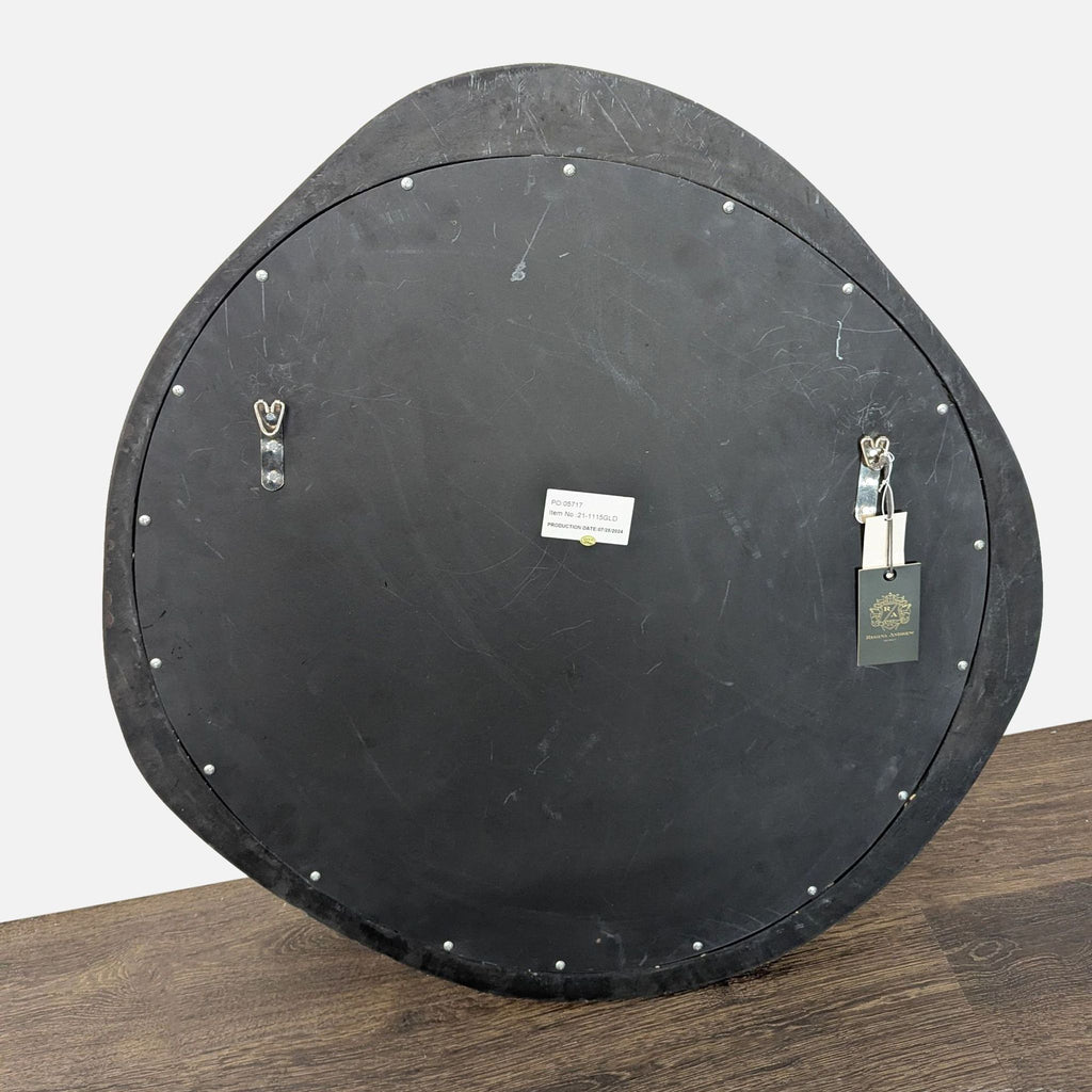 Organic-shaped Regina Andrew mirror featuring a gently wavy round form and classic antique finish.