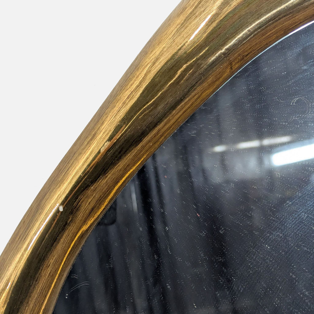 Regina Andrew Ibiza Mirror in an undulating circular design with a vintage-inspired resin and glass frame.