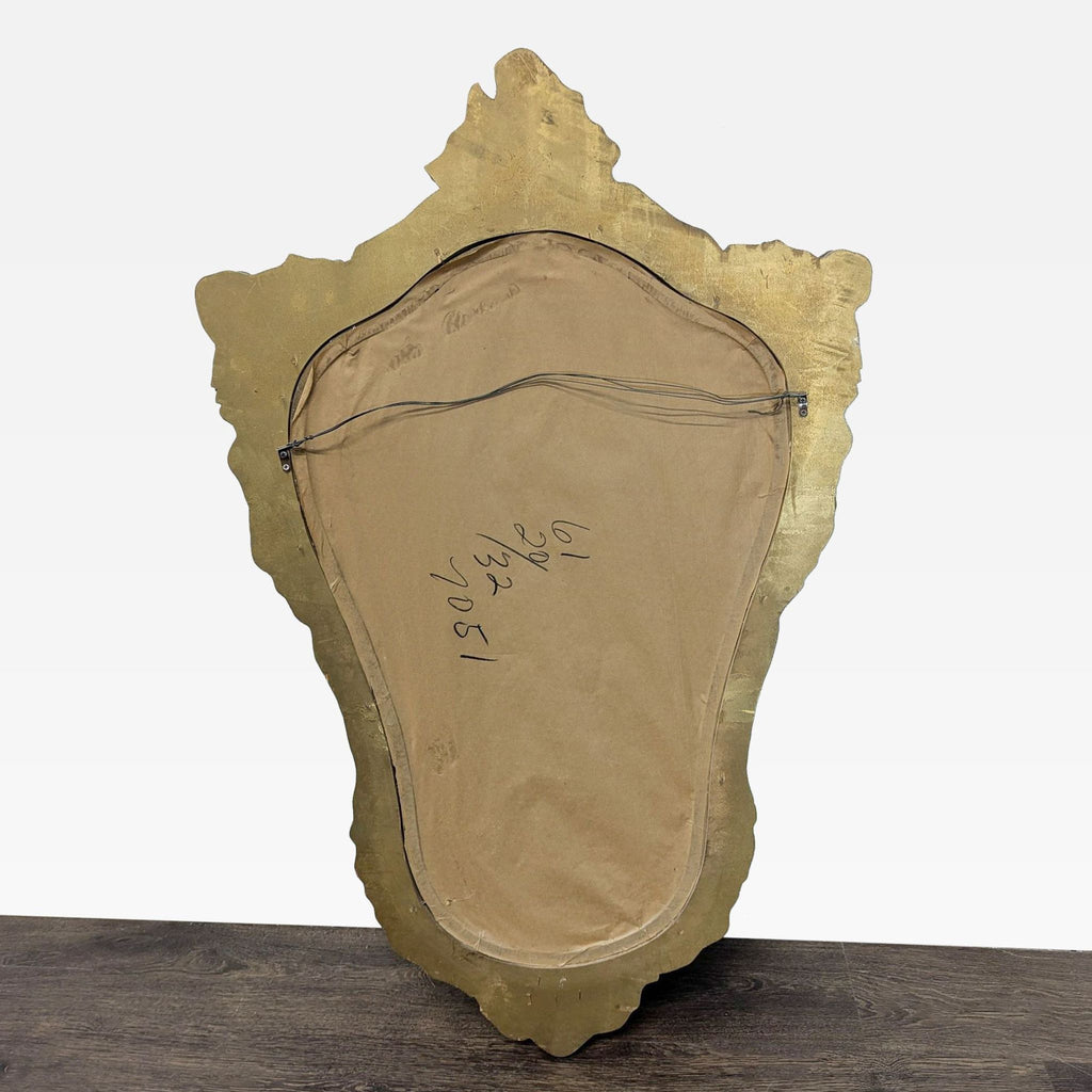 Decorative mirror framed by floral motifs and surrounded with detailed beading.
