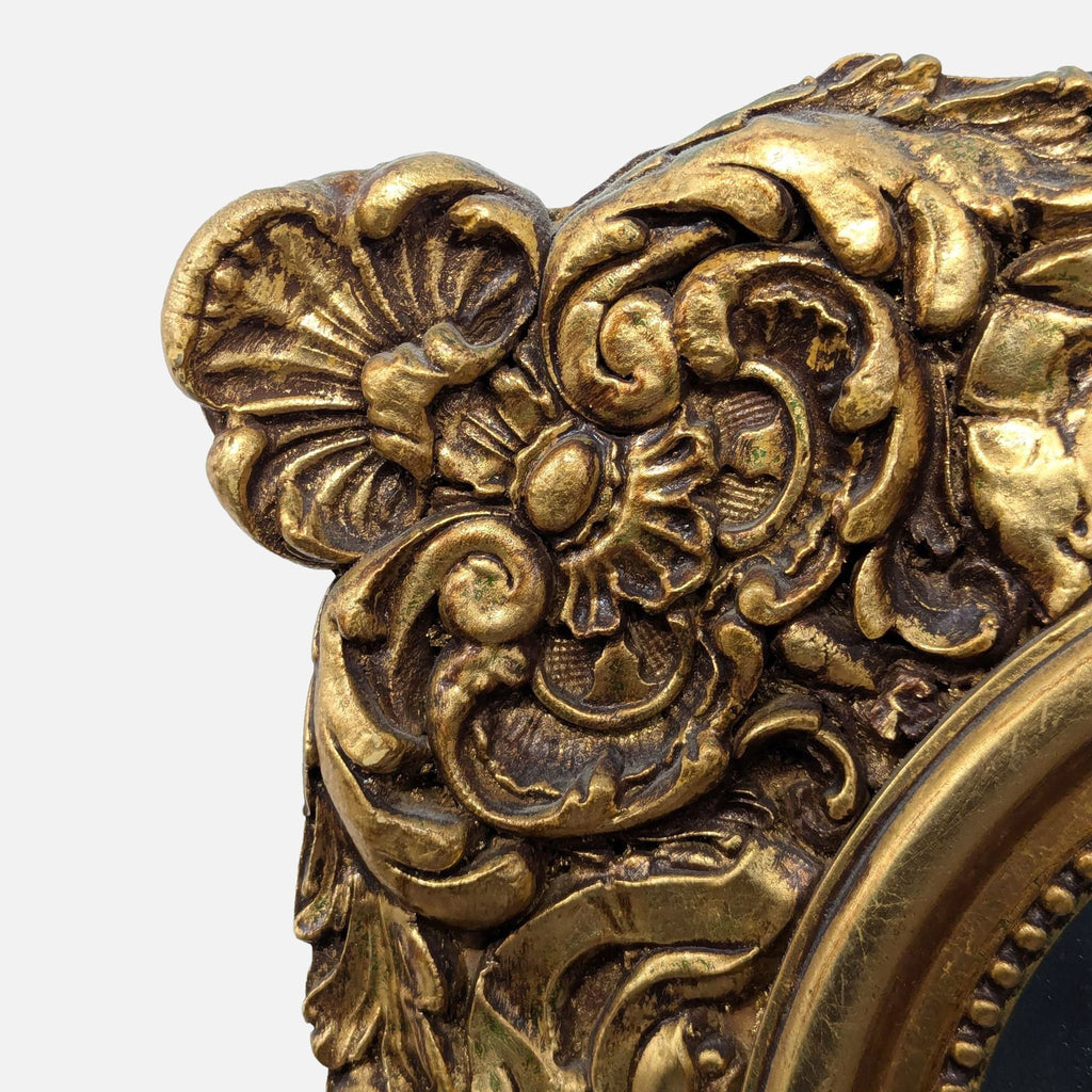 Mirror with intricate floral carvings and a beaded frame accentuating the glass.