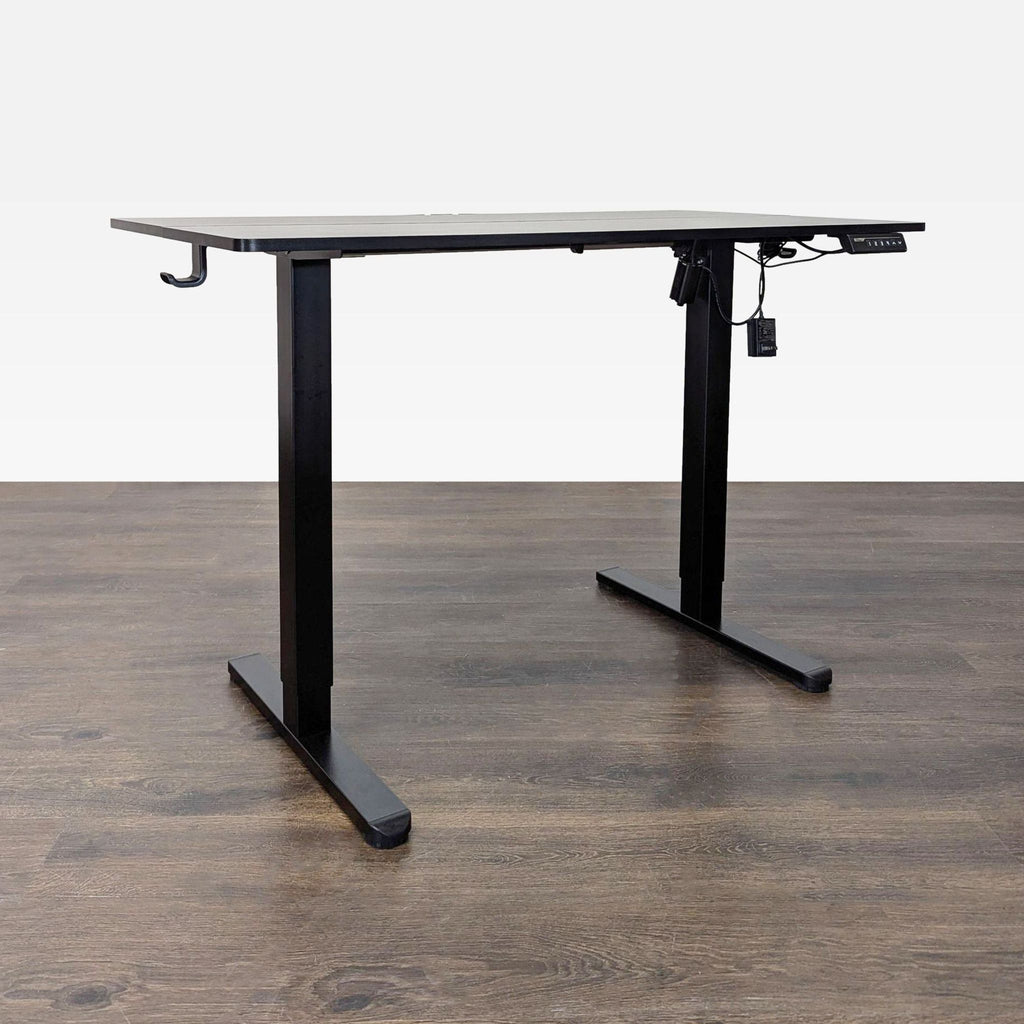 Modern ErGear desk offers easy sit-stand adjustment, sturdy black frame, wide surface, and built-in headphone hook.
