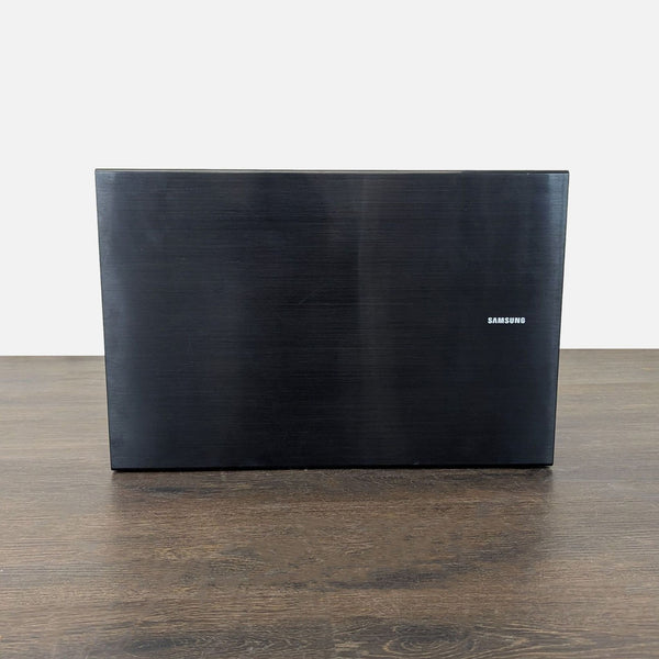 Samsung curved LED TV with modern stand, clean back, and easy room integration, in good condition.