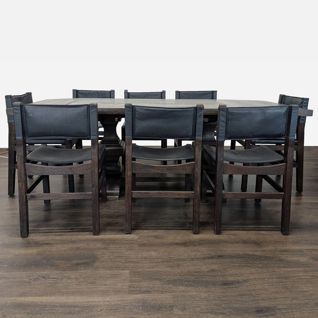 Restoration Hardware wood dining table with rustic finish and eight Pottery Barn chairs with black leather.