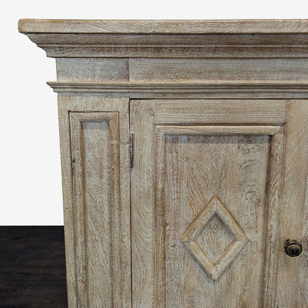 Grey credenza with paneled doors, diamond motifs, bun feet, and interior shelves, ideal for stylish storage.