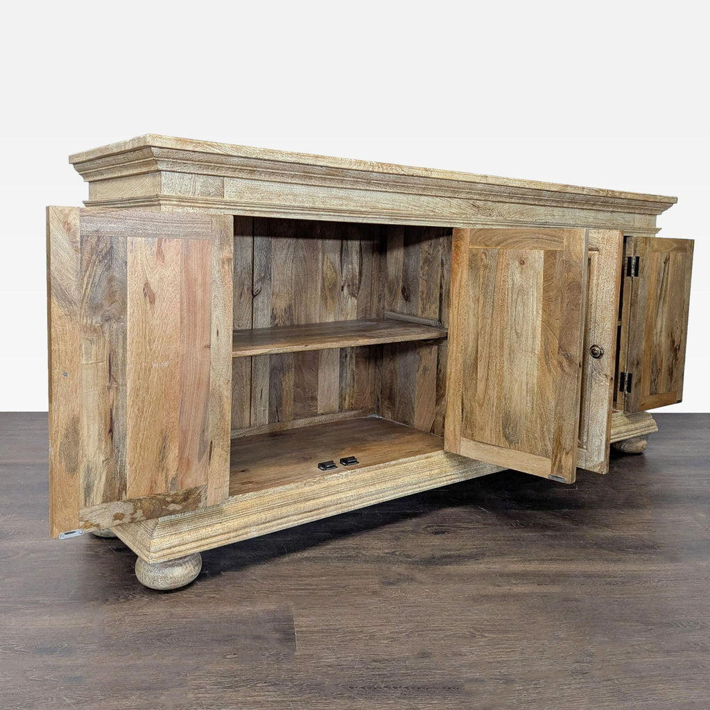 Buffet with molded front panels, diamond door accents, and a grey washed finish, featuring shelving inside.  