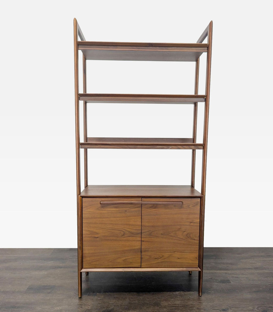 Crate & Barrel walnut bookshelf with three open shelves and a two-door cabinet for versatile storage.